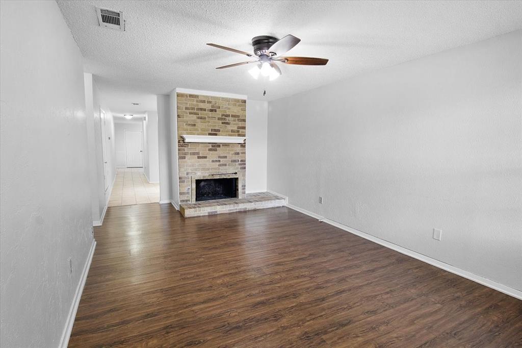1903 Wyndemere Lane Garland, TX 75042 - Photo 5 of 28 wooden floor in an empty room with a window