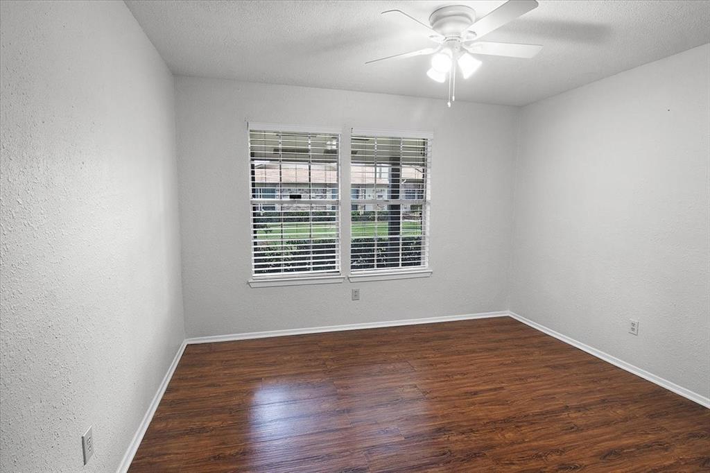 1903 Wyndemere Lane Garland, TX 75042 - Photo 6 of 28 a view of an empty room with wooden floor and a window