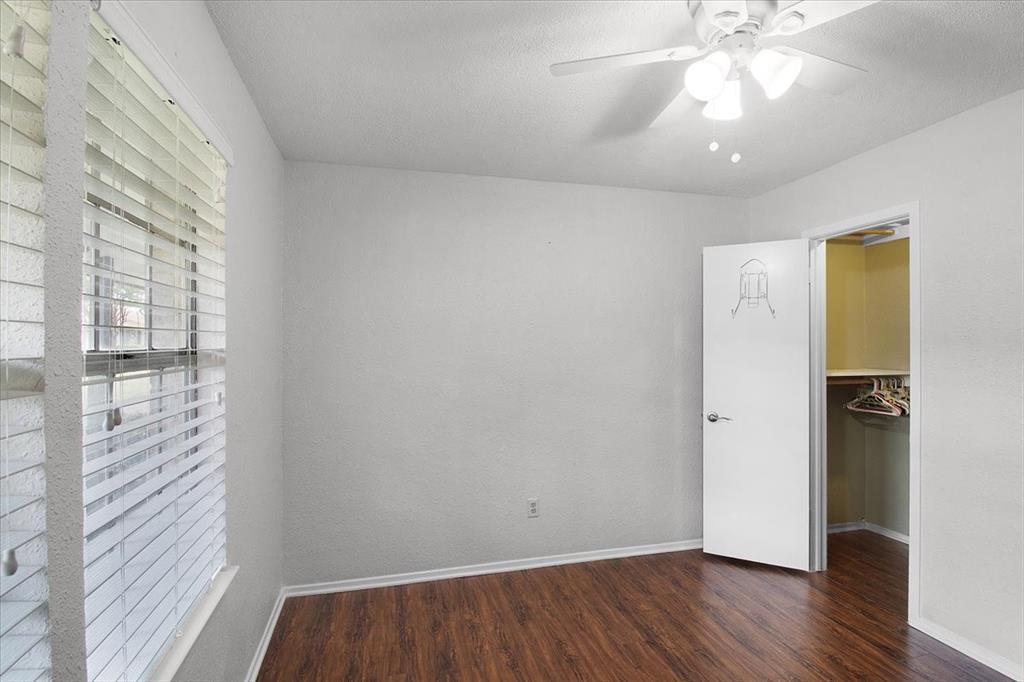 1903 Wyndemere Lane Garland, TX 75042 - Photo 7 of 28 a view of an empty room with wooden floor and a window