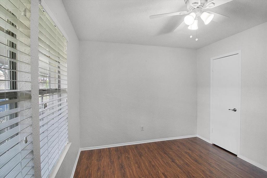 1903 Wyndemere Lane Garland, TX 75042 - Photo 8 of 28 a view of an empty room with wooden floor and a window