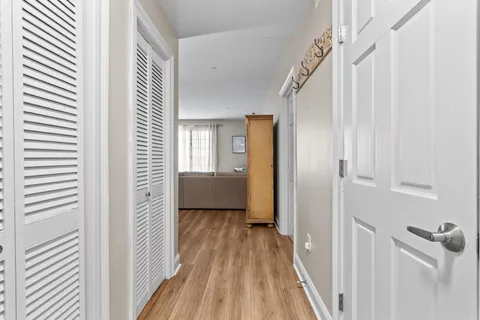 a view of a room with wooden floor stairs and a bathroom
