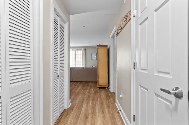 a view of a room with wooden floor stairs and a bathroom