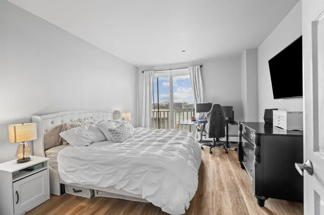 a bedroom with a bed and a flat screen tv