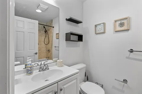 a bathroom with a sink toilet and shower