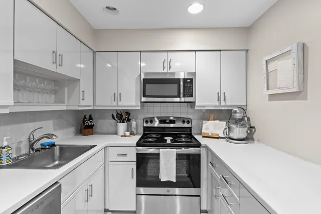 a kitchen with a sink and a stove top oven