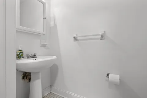 a bathroom with a sink a toilet and mirror