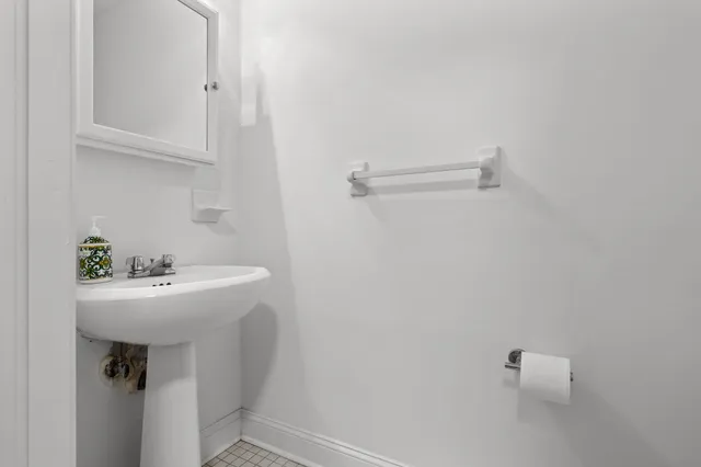 a bathroom with a sink a toilet and mirror