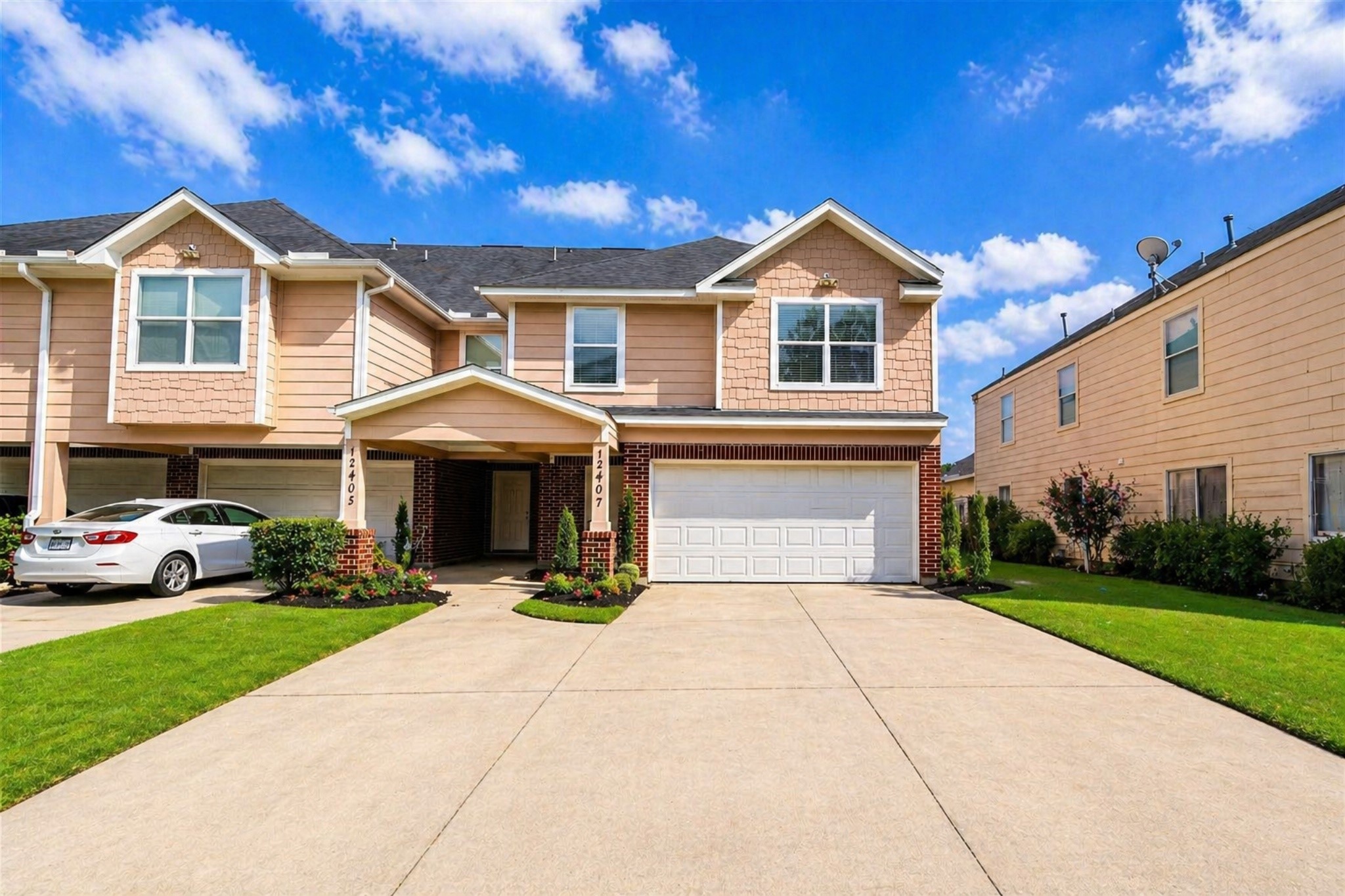 a front view of a house with a yard and garage