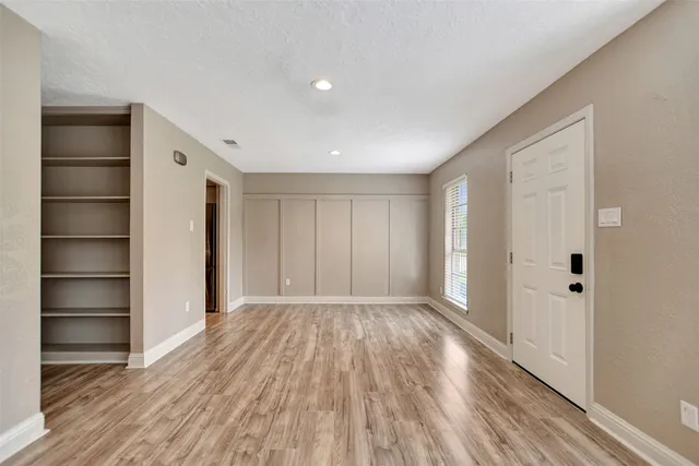 a view of an empty room with a closet