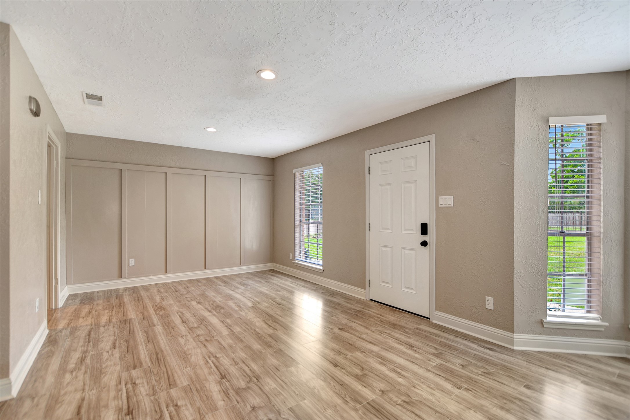 3826 Willow Springs Lane, Unit 3826 Houston, TX 77080 - Photo 13 of 43 a view of an empty room with wooden floor and a window