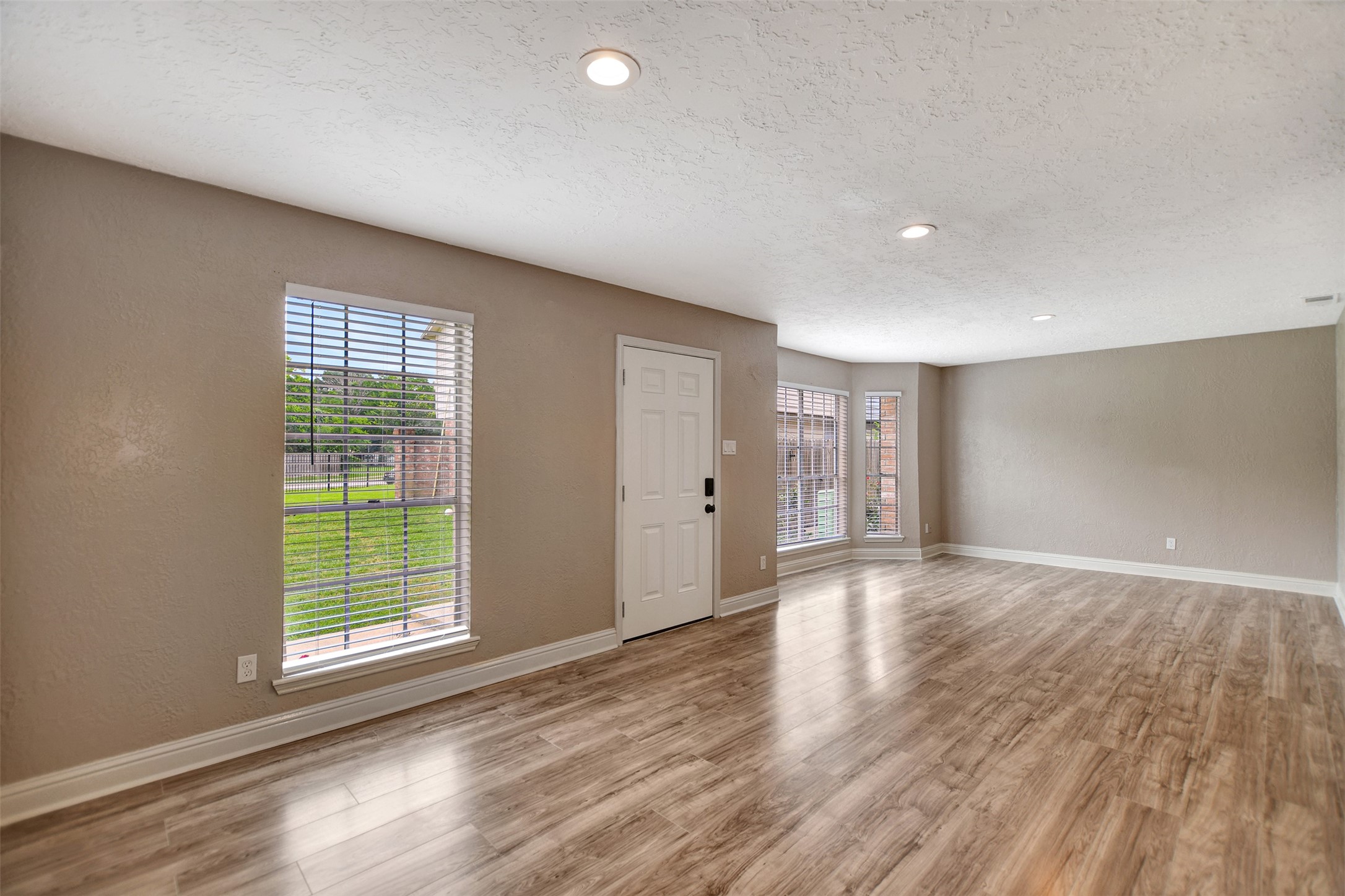 3826 Willow Springs Lane, Unit 3826 Houston, TX 77080 - Photo 15 of 43 a view of an empty room with wooden floor and a window