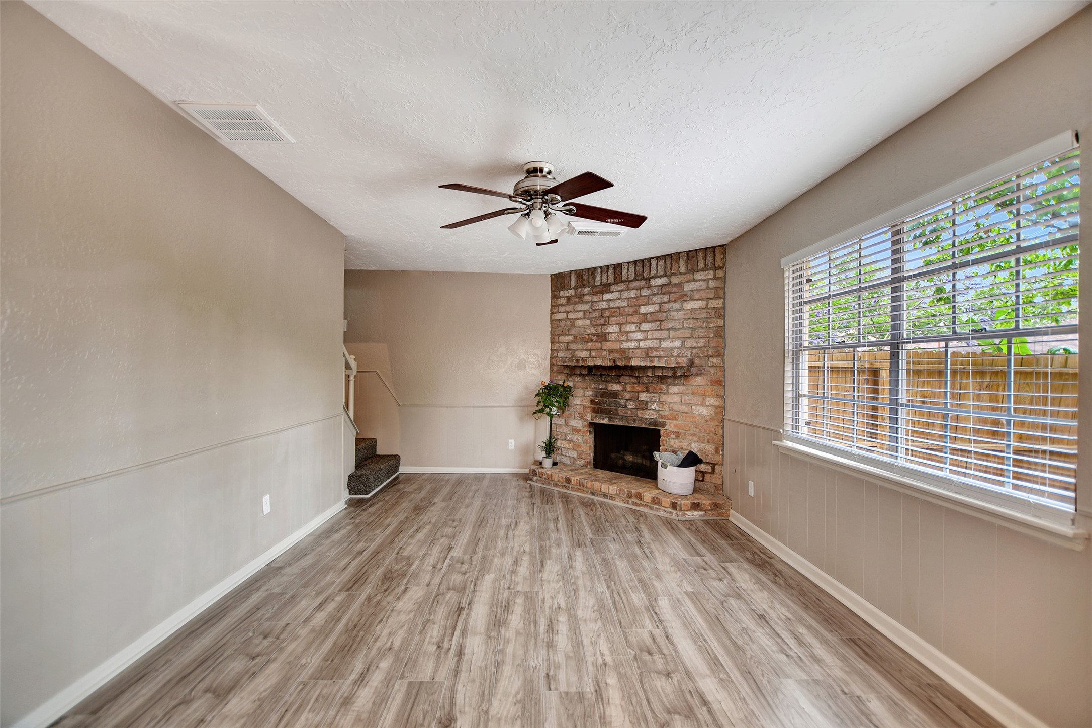3826 Willow Springs Lane, Unit 3826 Houston, TX 77080 - Photo 19 of 43 wooden floor in an empty room with a fireplace