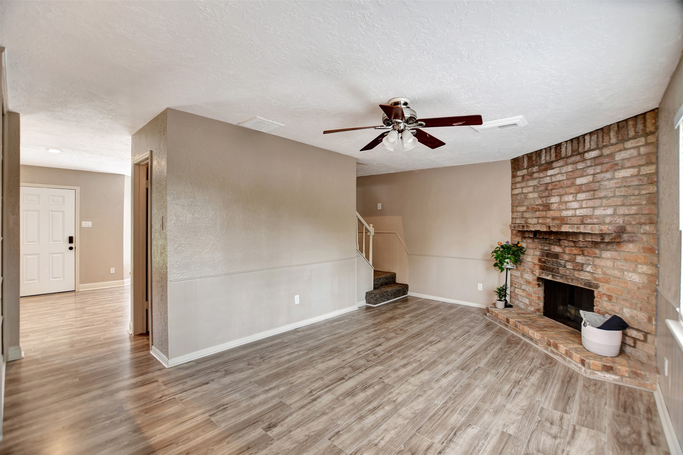 3826 Willow Springs Lane, Unit 3826 Houston, TX 77080 - Photo 20 of 43 a view of empty room with a fireplace and wooden floor