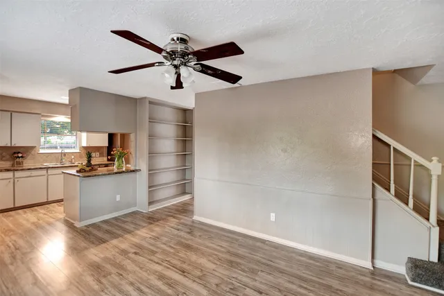 a kitchen with a refrigerator and white cabinets