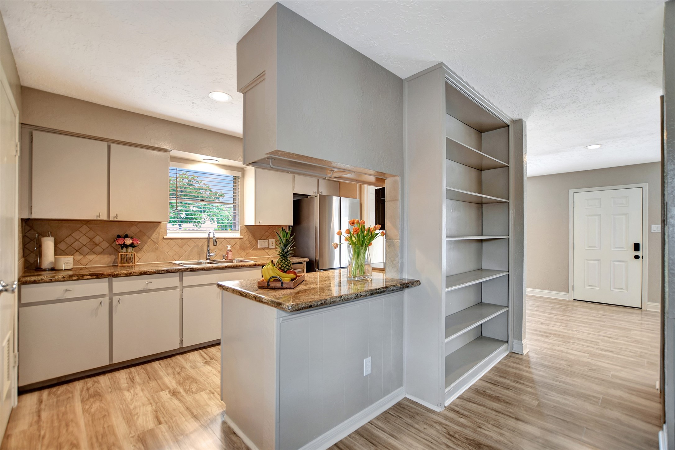 3826 Willow Springs Lane, Unit 3826 Houston, TX 77080 - Photo 24 of 43 a kitchen with kitchen island granite countertop a sink cabinets and stainless steel appliances