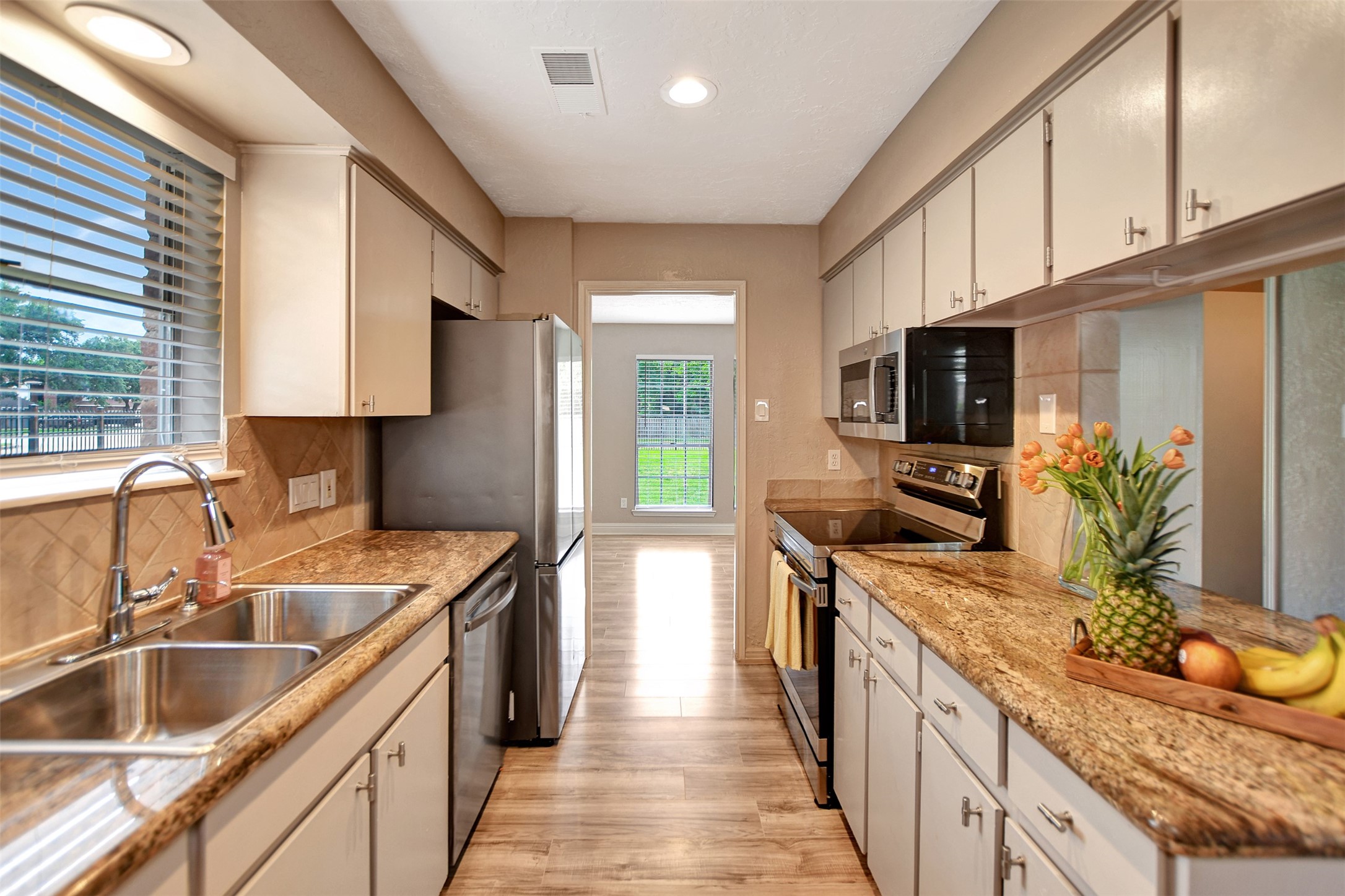 3826 Willow Springs Lane, Unit 3826 Houston, TX 77080 - Photo 26 of 43 a kitchen with granite countertop a sink stove and refrigerator