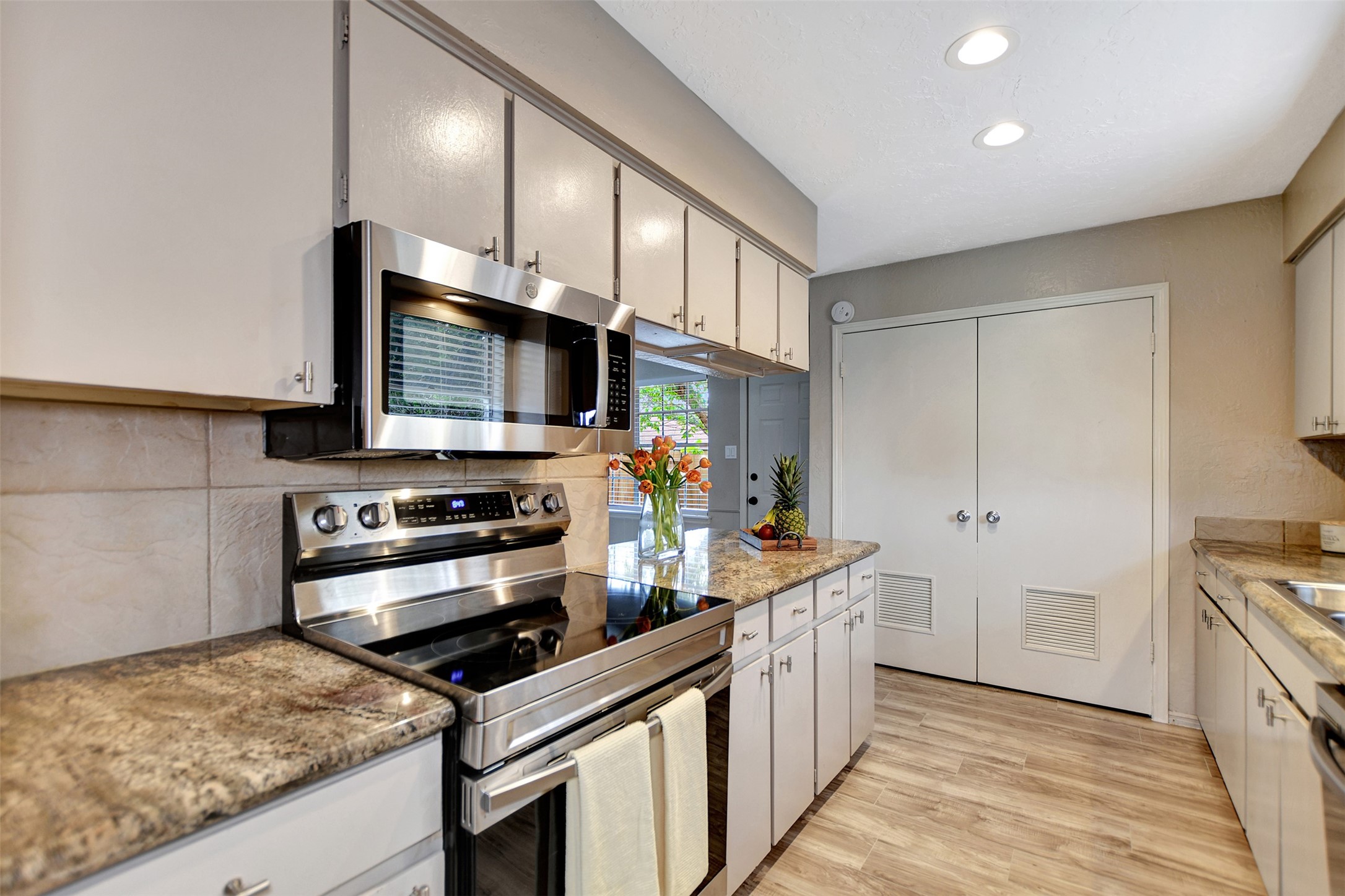 3826 Willow Springs Lane, Unit 3826 Houston, TX 77080 - Photo 28 of 43 a kitchen with stainless steel appliances granite countertop a stove a sink and a refrigerator