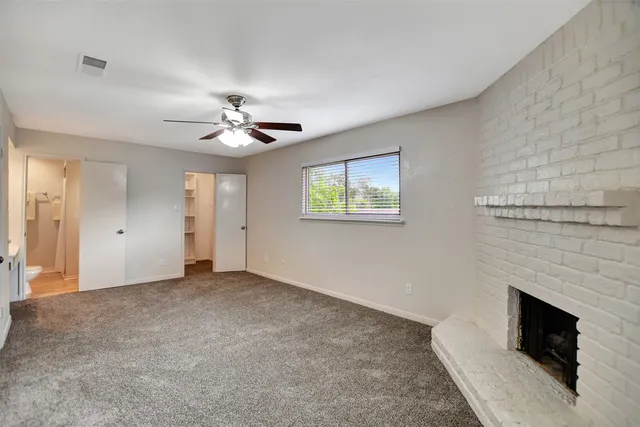 a view of a livingroom with a ceiling fan and window
