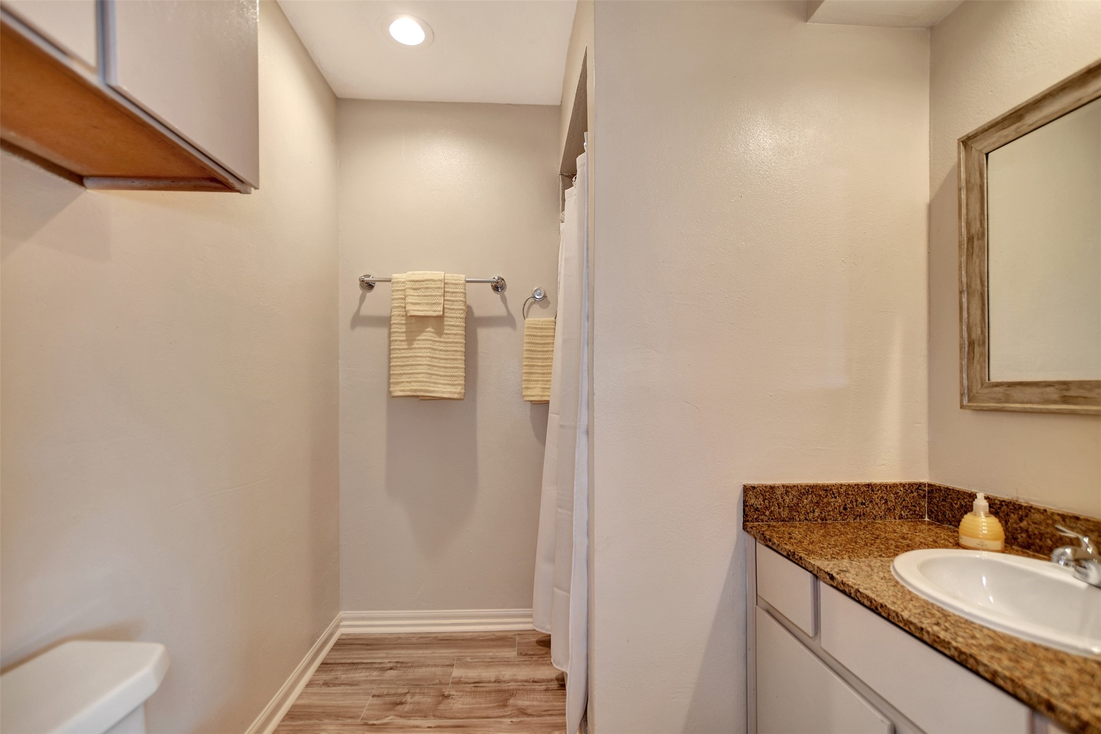 3826 Willow Springs Lane, Unit 3826 Houston, TX 77080 - Photo 34 of 43 a bathroom with a granite countertop sink and a mirror