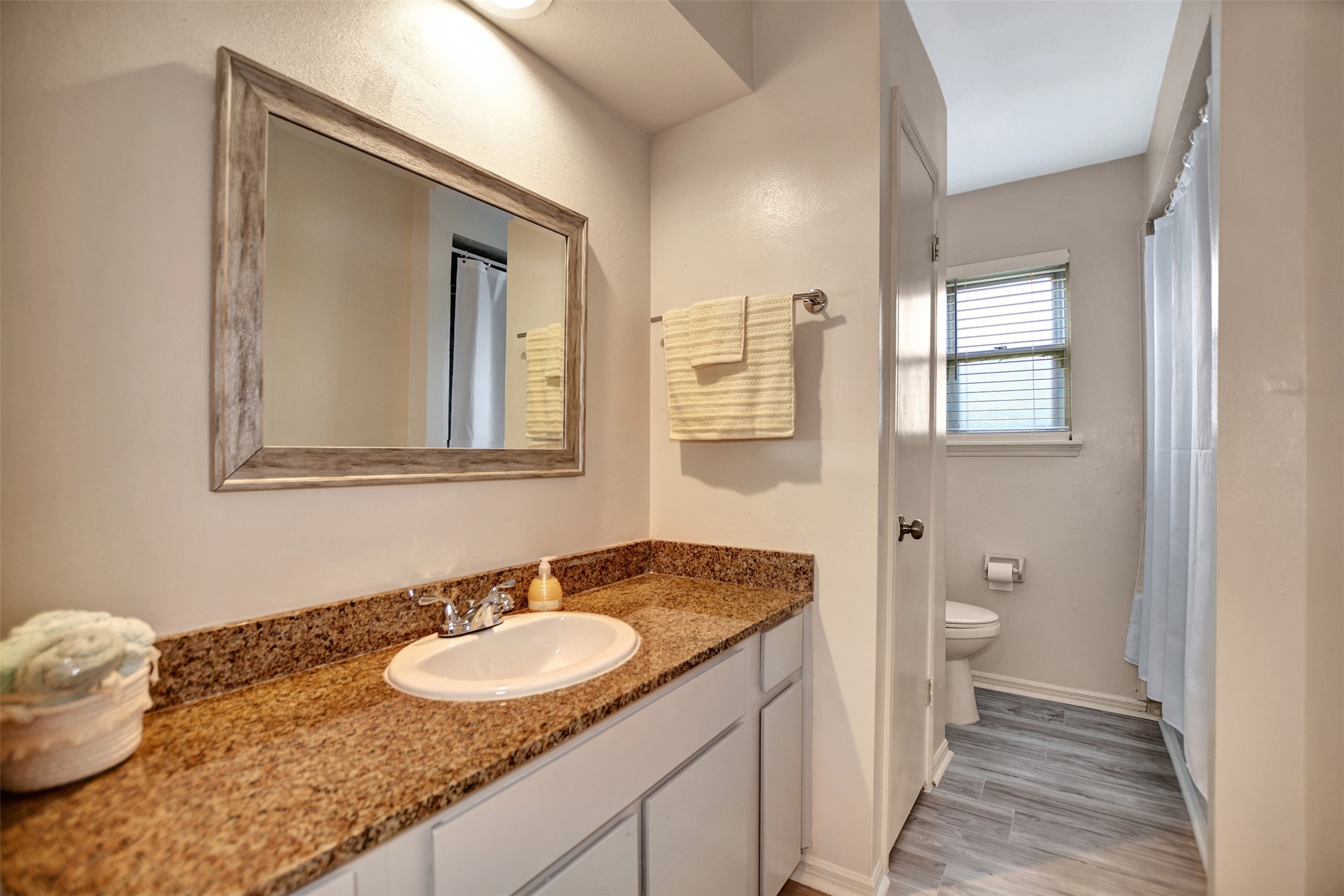 3826 Willow Springs Lane, Unit 3826 Houston, TX 77080 - Photo 39 of 43 a bathroom with a granite countertop sink and a mirror