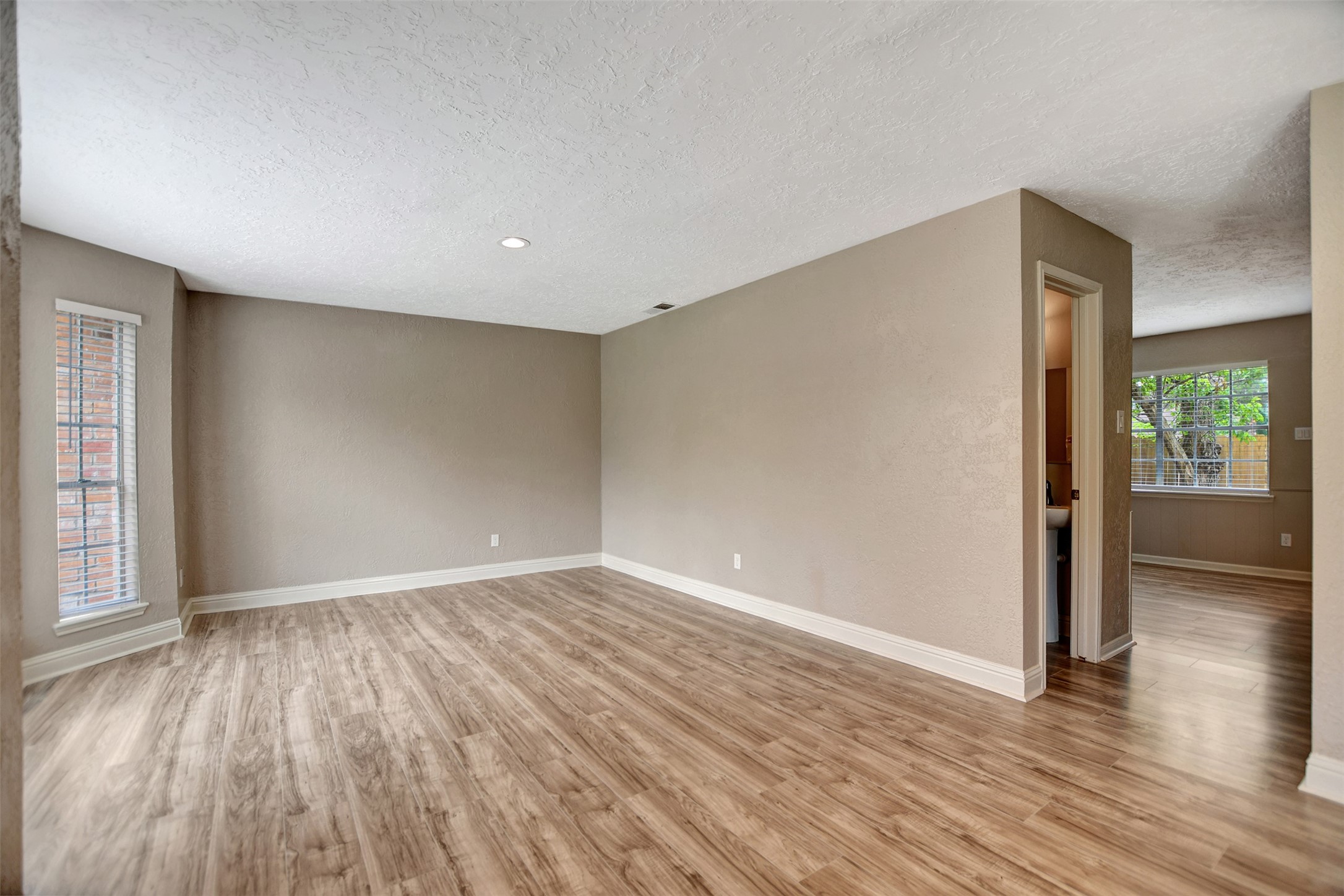 3826 Willow Springs Lane, Unit 3826 Houston, TX 77080 - Photo 7 of 43 wooden floor in an empty room with a window