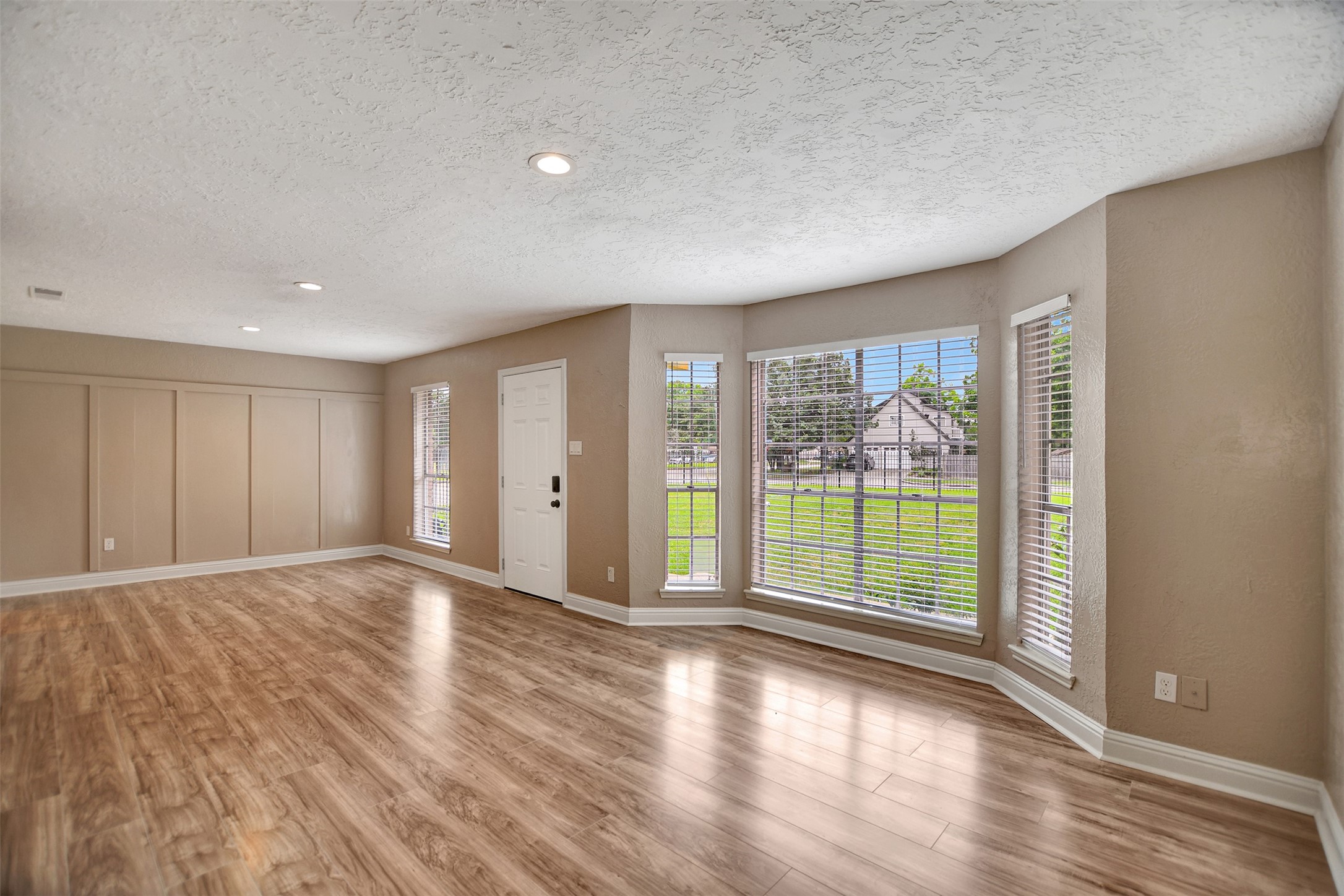 3826 Willow Springs Lane, Unit 3826 Houston, TX 77080 - Photo 10 of 43 a view of an empty room with wooden floor and a window