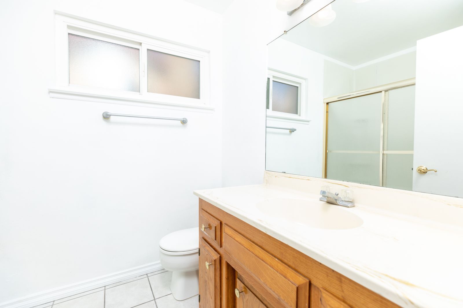 1225 North Erwin Street Ridgecrest, CA 93555 - Photo 23 of 27 a bathroom with a sink a toilet and a mirror