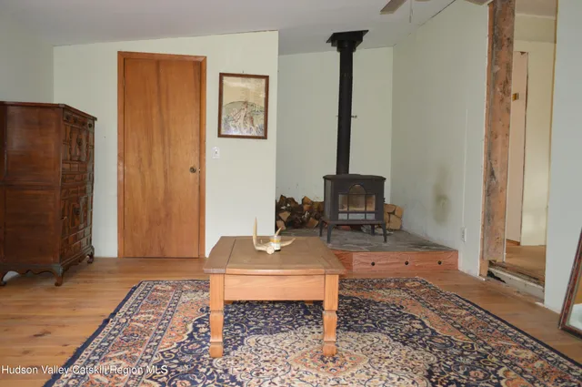 a living room with a table and a rug