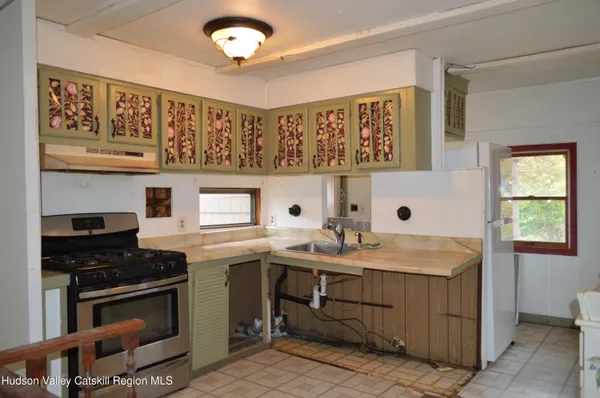 a kitchen with a sink stove and cabinets