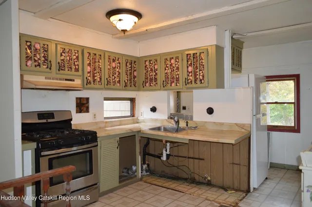 a kitchen with a sink stove and cabinets