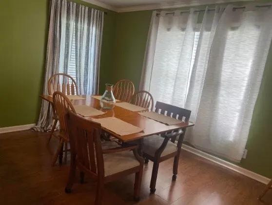 a view of a dining room with furniture and window