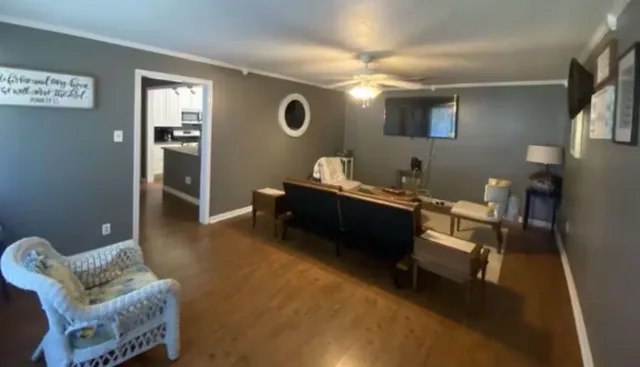 a living room with furniture and a large window