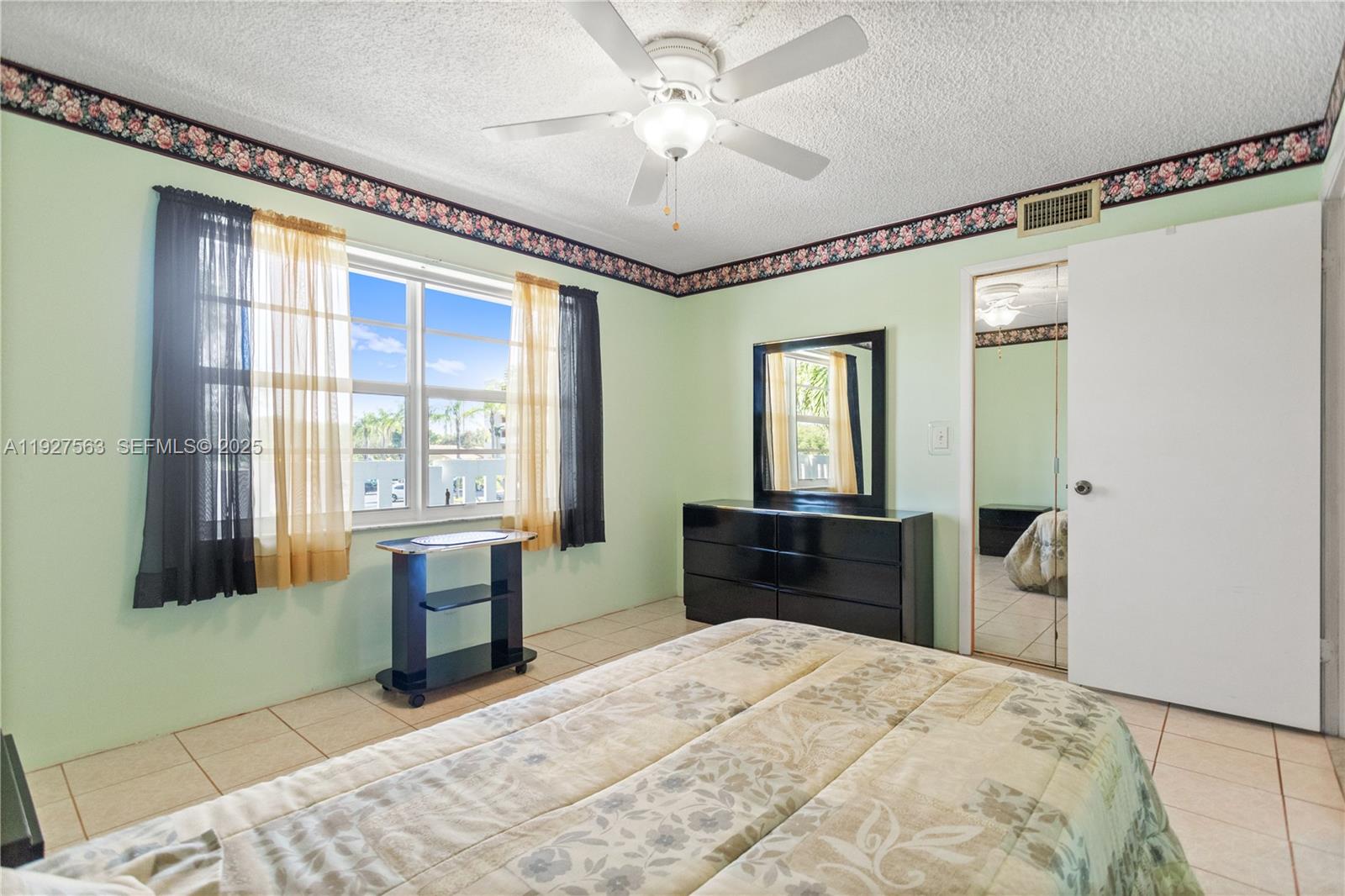 190 Southeast 5th Avenue, Unit 202 Dania Beach, FL 33004 - Photo 20 of 36 a bedroom with a bed and a dresser next to a window