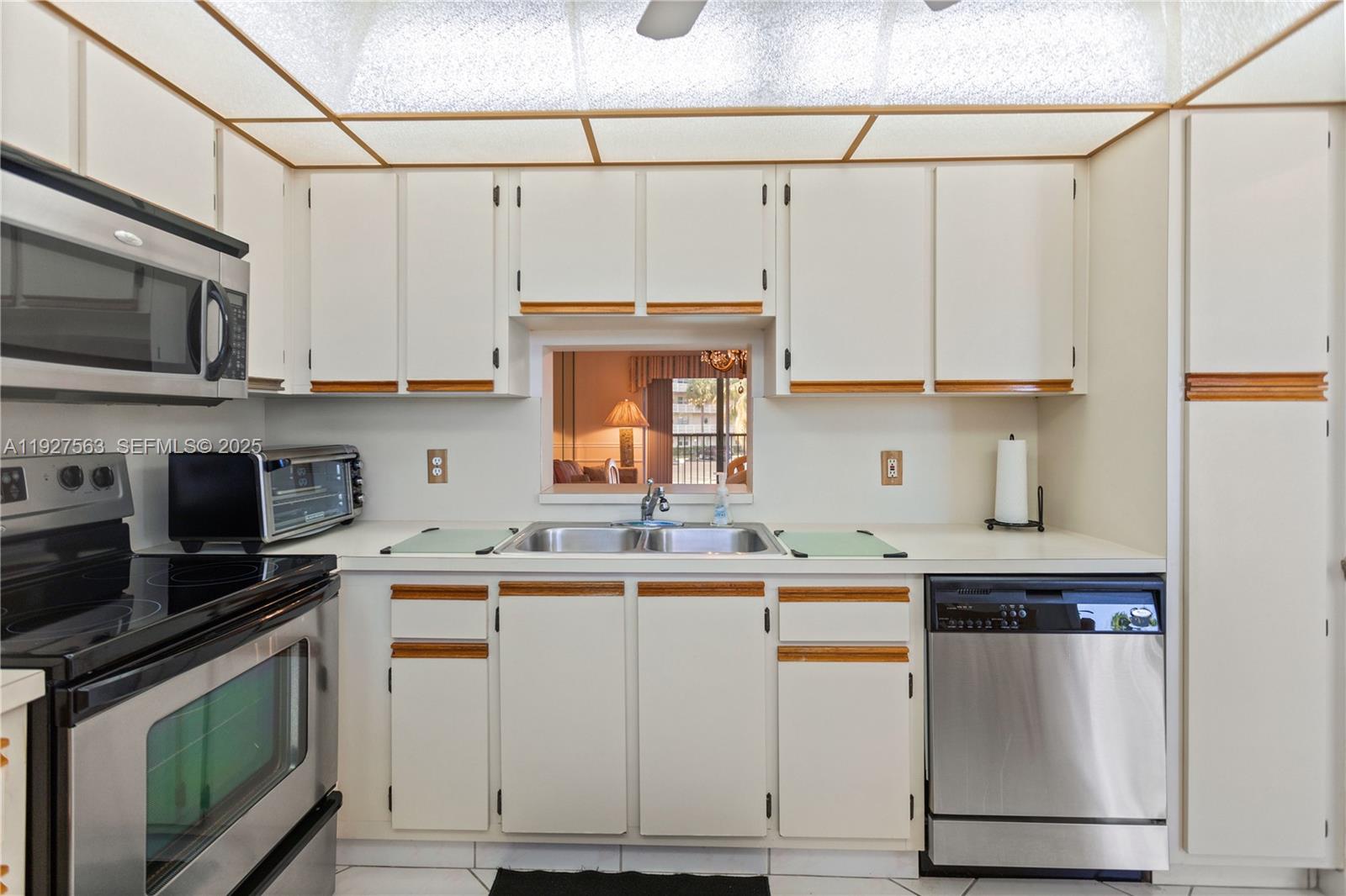 190 Southeast 5th Avenue, Unit 202 Dania Beach, FL 33004 - Photo 2 of 36 a kitchen with stainless steel appliances granite countertop a stove a sink and a microwave