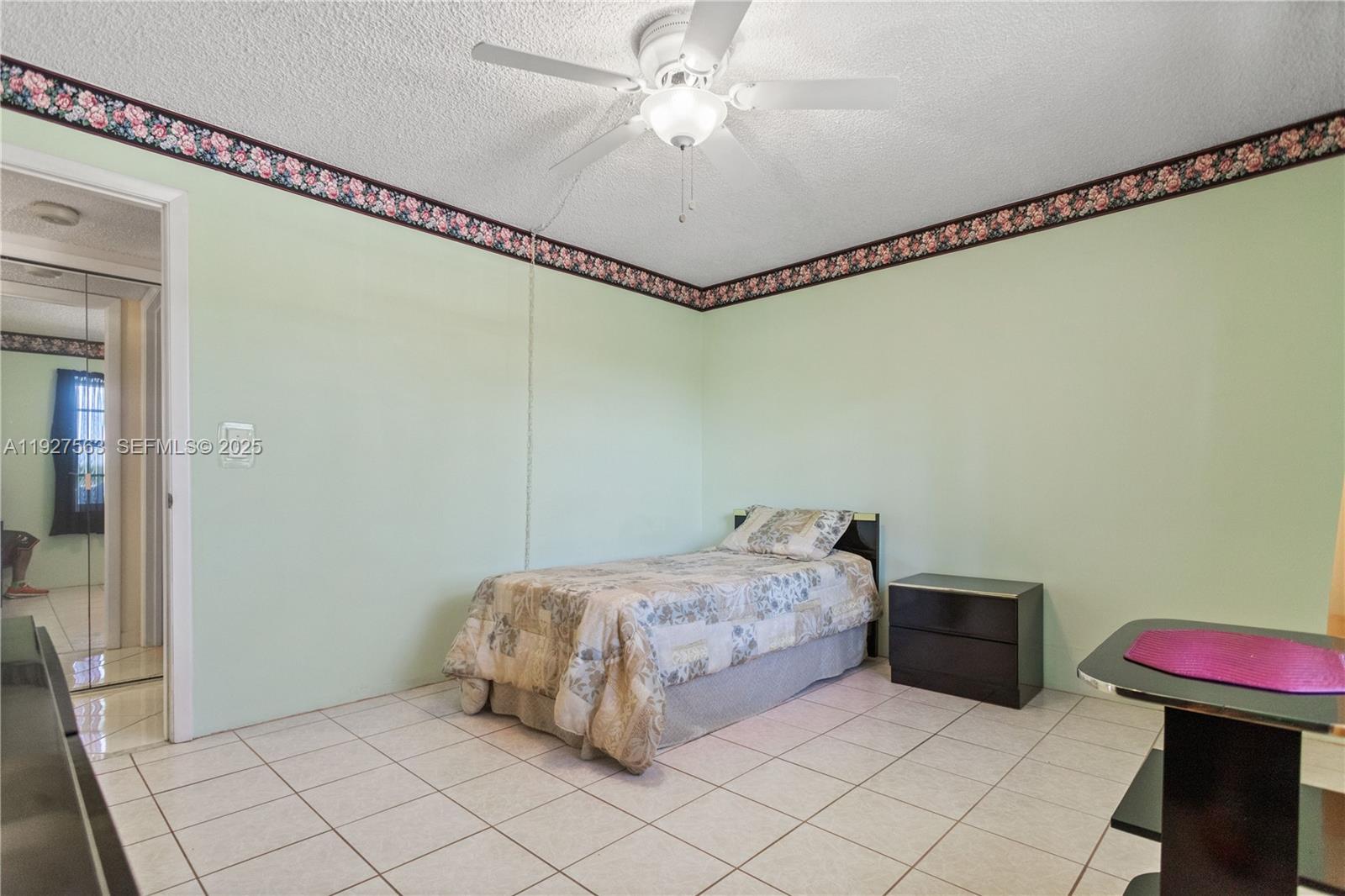190 Southeast 5th Avenue, Unit 202 Dania Beach, FL 33004 - Photo 21 of 36 a bedroom with a bed and a chandelier
