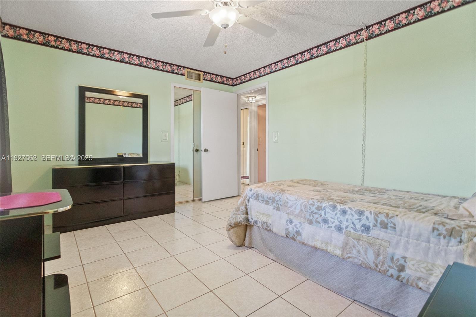 190 Southeast 5th Avenue, Unit 202 Dania Beach, FL 33004 - Photo 22 of 36 a bedroom with a bed and a mirror on dresser