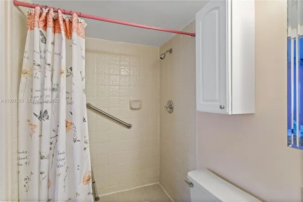 a bathroom with a shower and a toilet