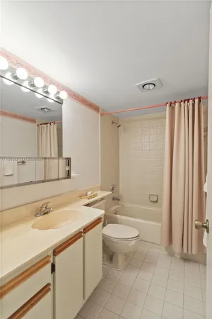 a bathroom with a sink a toilet and bathtub