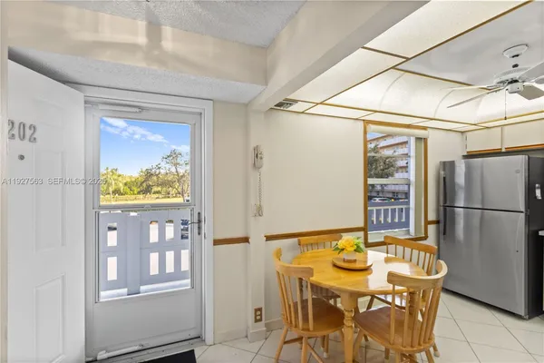 a view of a dining room with furniture and a window