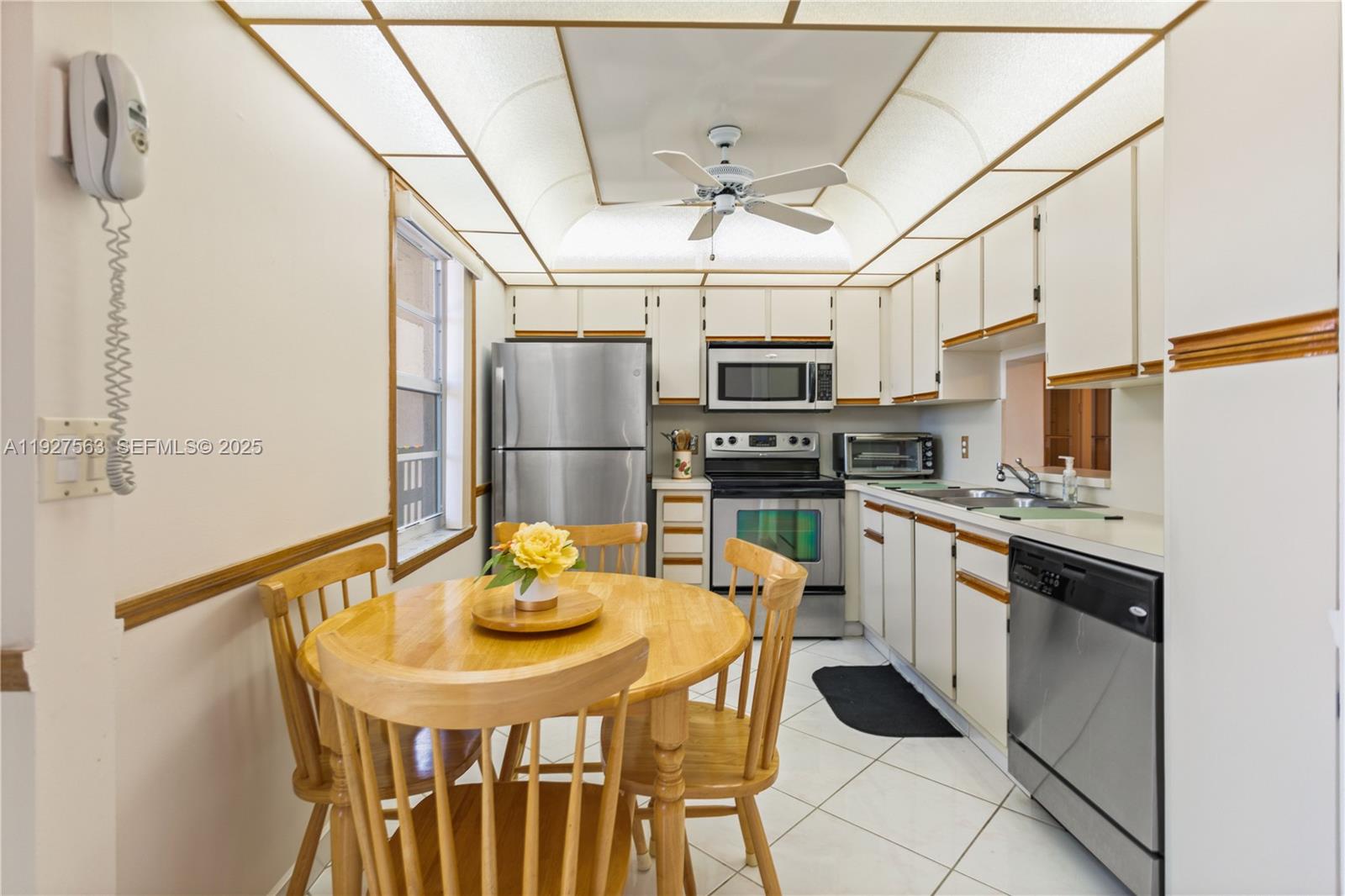 190 Southeast 5th Avenue, Unit 202 Dania Beach, FL 33004 - Photo 6 of 36 a kitchen with stainless steel appliances a refrigerator a stove a sink dishwasher a dining table and chairs with wooden floor