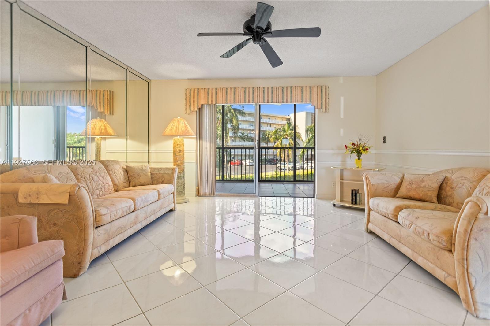 190 Southeast 5th Avenue, Unit 202 Dania Beach, FL 33004 - Photo 10 of 36 a living room with furniture and a large window