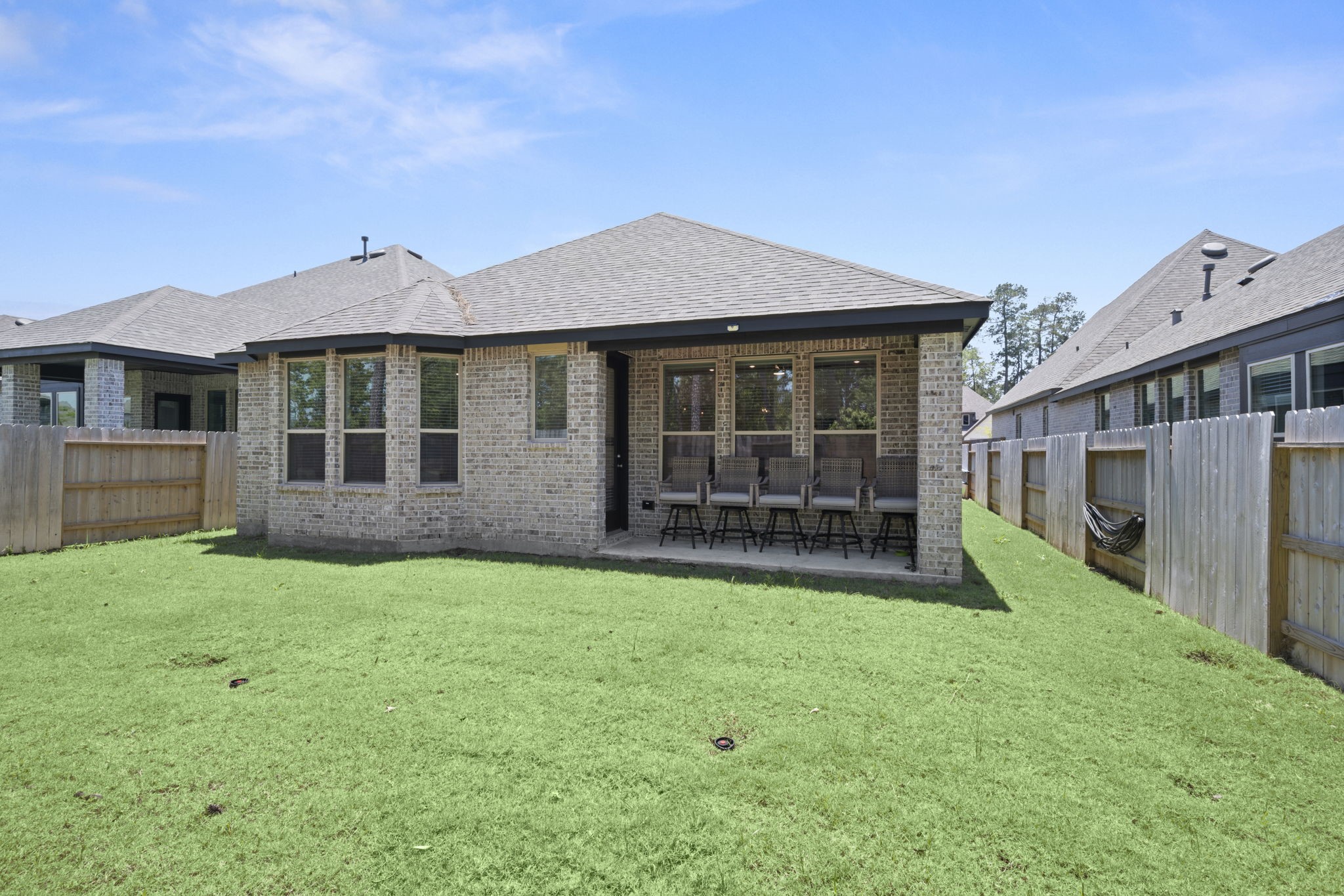 13035 Wandering Rdg Lane Conroe, TX 77302 - Photo 26 of 28 a view of a house with a yard and a porch