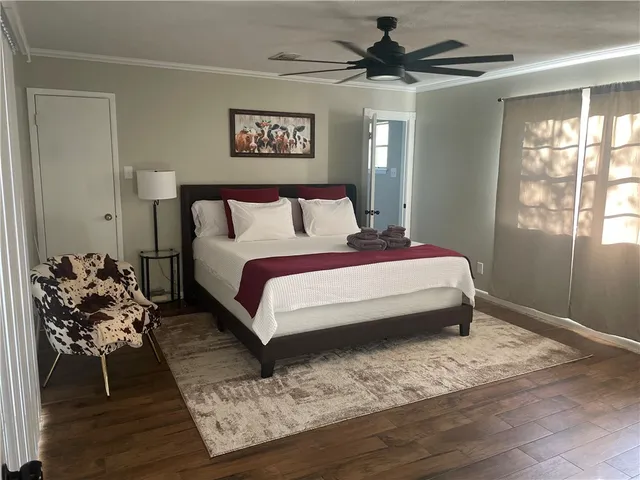 a bedroom with a bed mirror and window