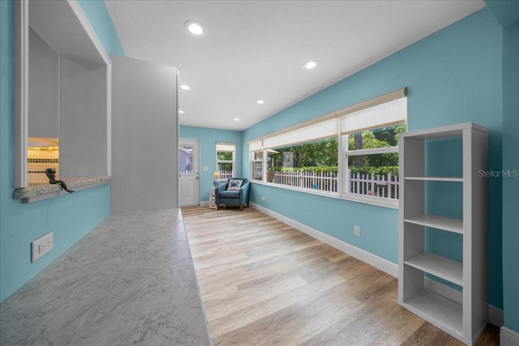 8720 Southwest 90th Street, Unit A Ocala, FL 34481 - Photo 20 of 71 a view of an empty room with a window and wooden floor