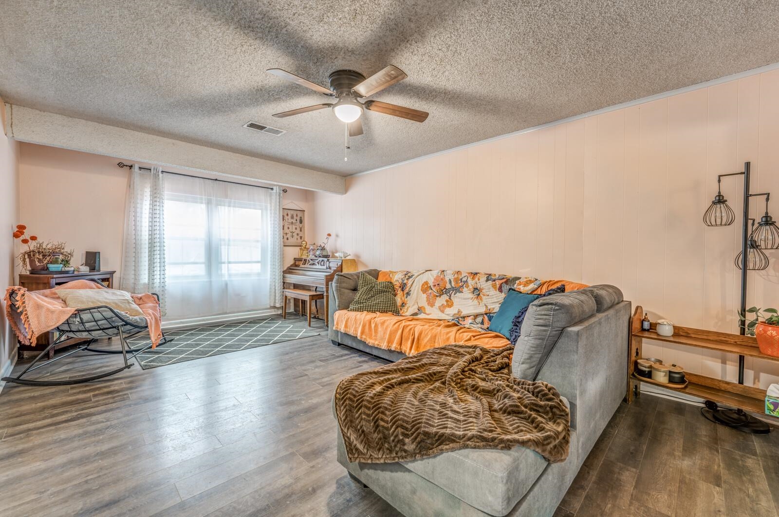 4660 Vincent Road Millington, TN 38053 - Photo 14 of 37 Living room with a textured ceiling, wood finished floors, visible vents, and a ceiling fan