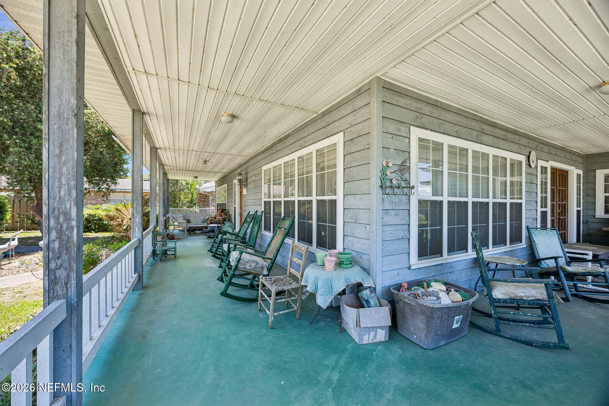 7430 Southwest County Road 18 Hampton, FL 32044 - Photo 9 of 72 a view of a patio with chairs potted plants and floor to ceiling window