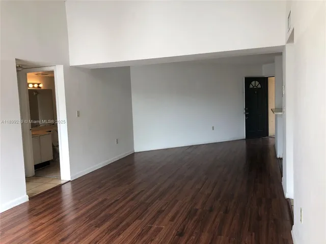 an empty room with wooden floor and closet