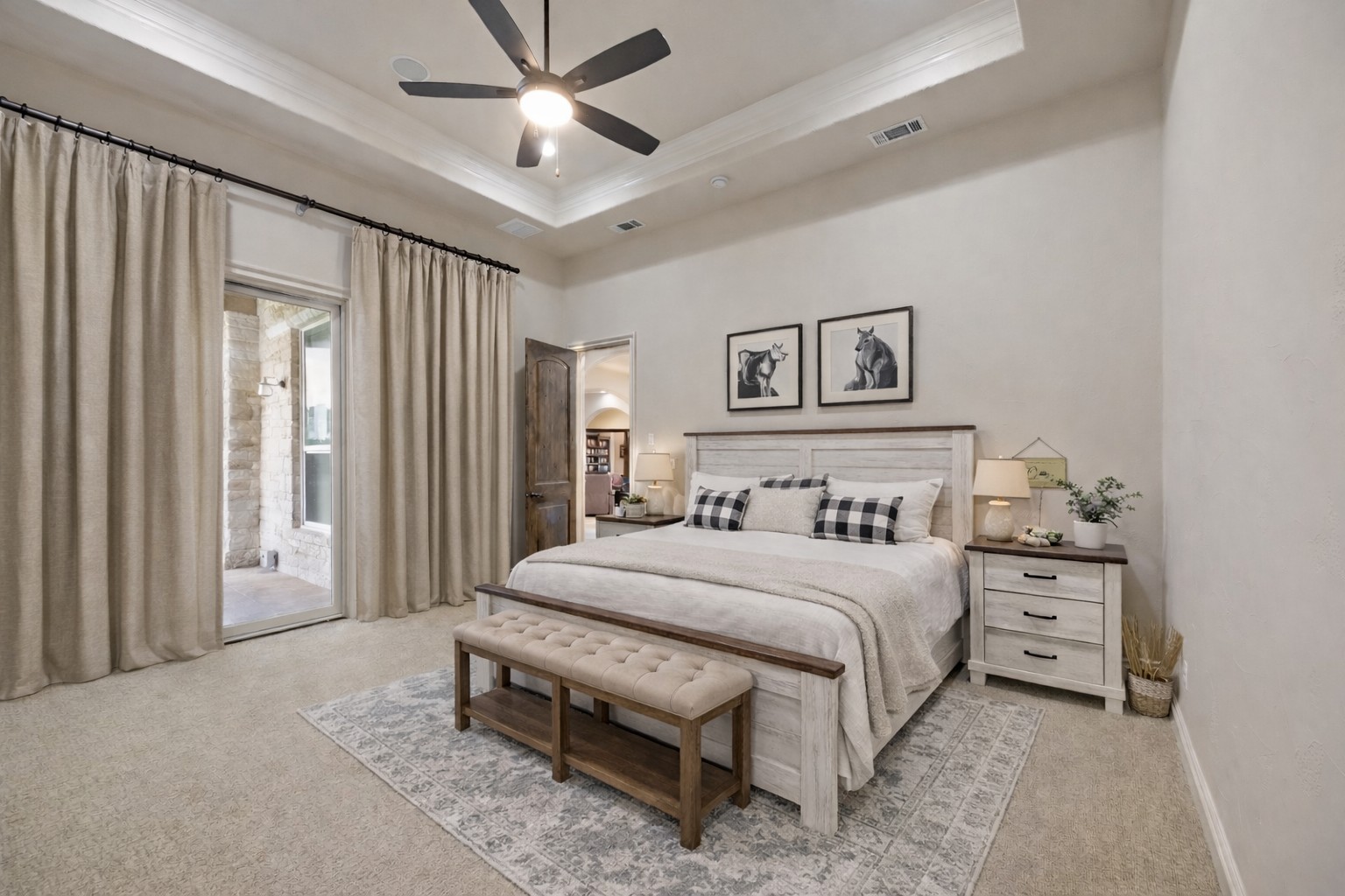 109 Ranchers Club Lane Driftwood, TX 78619 - Photo 12 of 19 Bedroom featuring access to outside, light carpet, ceiling fan, crown molding, and a tray ceiling