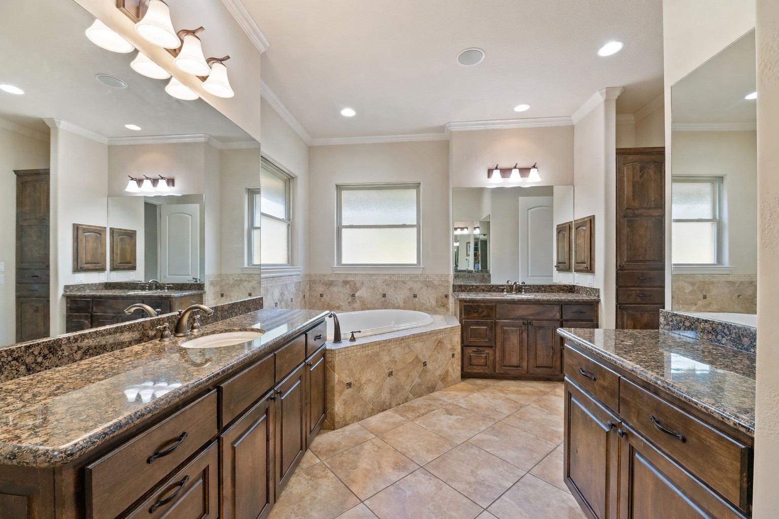 109 Ranchers Club Lane Driftwood, TX 78619 - Photo 13 of 19 Bathroom featuring a bath, crown molding, and two vanities