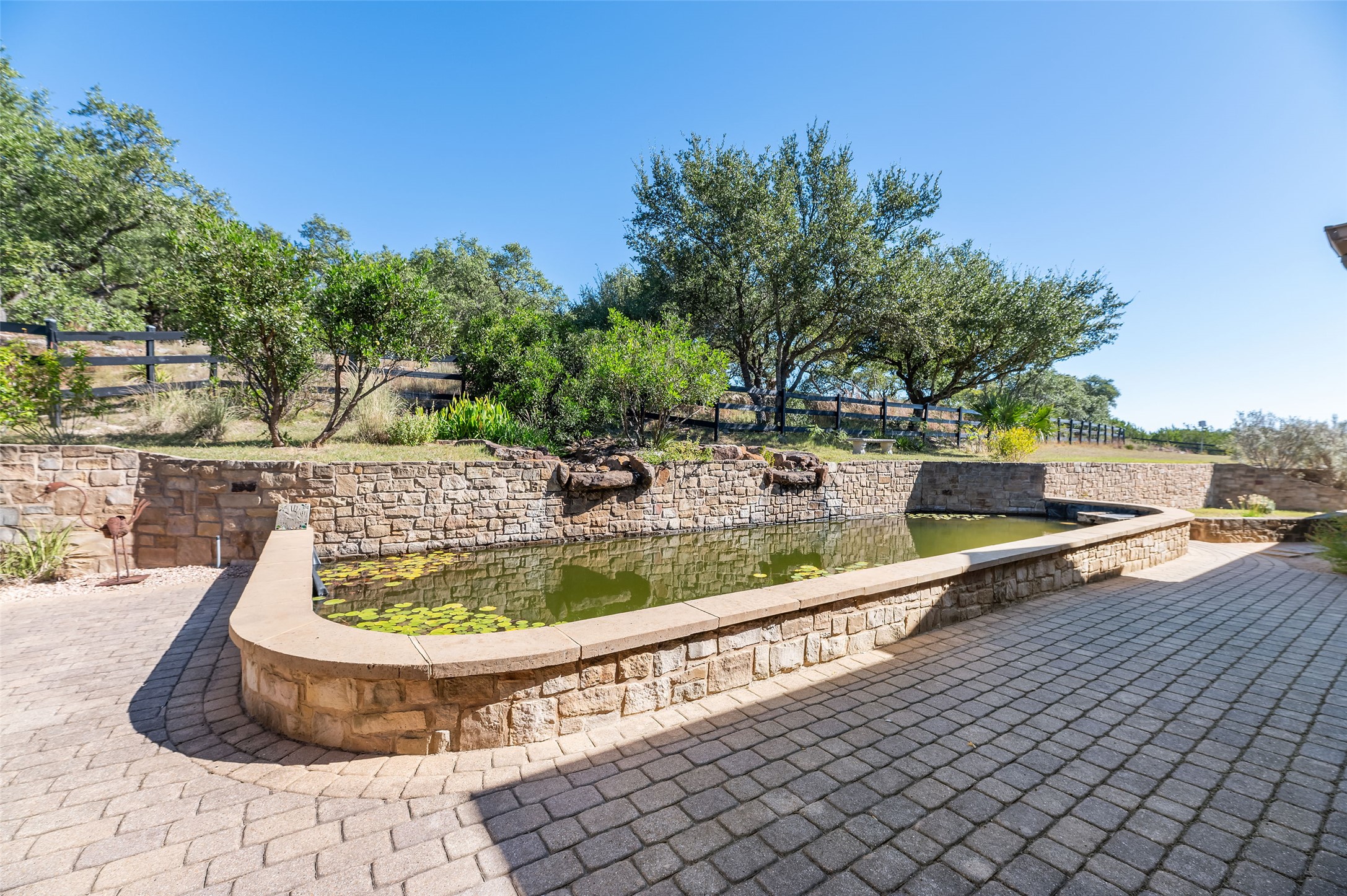 109 Ranchers Club Lane Driftwood, TX 78619 - Photo 16 of 19 View of pond with waterfall